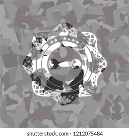 dumbbell icon inside grey camo emblem