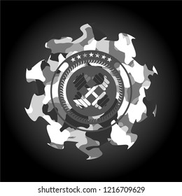 dumbbell icon inside grey camo emblem