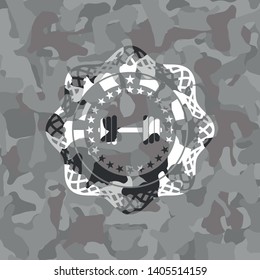 dumbbell icon inside grey camouflage emblem