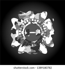 dumbbell icon inside grey camouflaged emblem