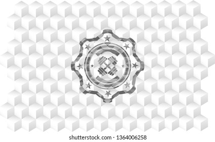 dumbbell icon inside grey emblem with geometric cube white background