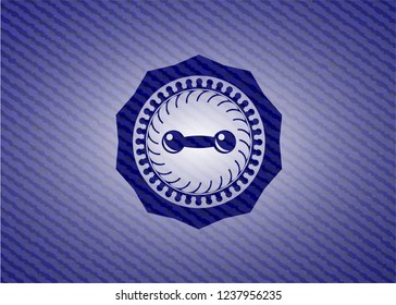 dumbbell icon inside jean or denim emblem or badge background