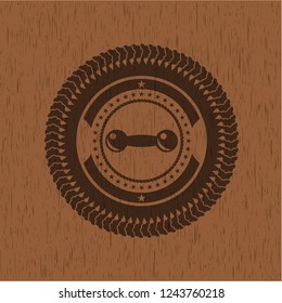 dumbbell icon inside realistic wood emblem