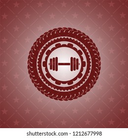 dumbbell icon inside red emblem