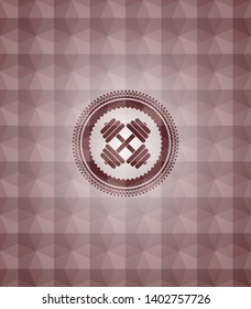 dumbbell icon inside red seamless emblem or badge with geometric pattern background.