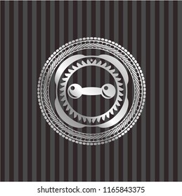 dumbbell icon inside silver badge or emblem