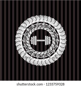 dumbbell icon inside silver emblem or badge