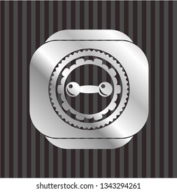 dumbbell icon inside silvery emblem