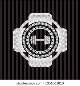 dumbbell icon inside silvery emblem