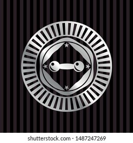 dumbbell icon inside silvery emblem