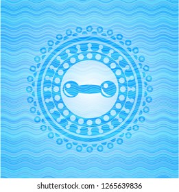 dumbbell icon inside water representation style badge.