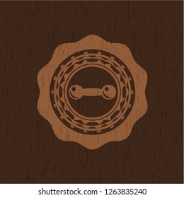dumbbell icon inside wood badge or emblem