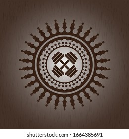 dumbbell icon inside wooden emblem