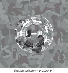 dumbbell icon on grey camouflaged texture