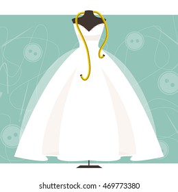 Dummy with wedding dress and centimeter on sewing background