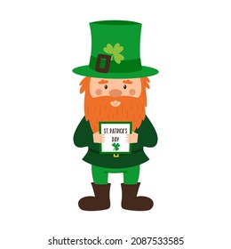 A dwarf with a red beard and a green hat with a clover is holding a sign with the words St. Patrick's Day. A postcard with a little gnome. Cute cartoon character isolated on a white background