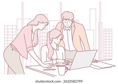 A dynamic team collaborates on a shared laptop, showcasing teamwork and innovation in a vibrant workplace