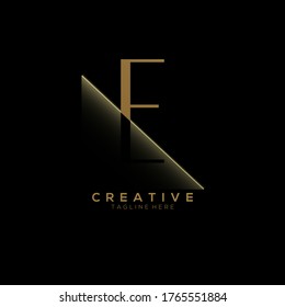 E Gold Letter Logo Design with Creative Paper Cut
