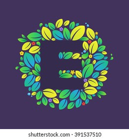E letter logo in a circle of leaves and flowers. Font style, vector design template elements for your vegan or ecology application or corporate identity.