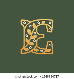 E letter logo consisting of floral pattern letters with chamomile flower. Linear classic vector font. Can be used for cosmetics, spa, beauty salon, decoration, boutique, jewelry and fashion industry.