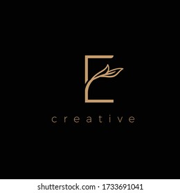 E LETTER LOGO LUXURY WITH DRAWING LEAF