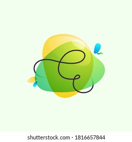 E letter logo placed on green watercolor blots. Overlapping splashes typeface can be used for ecology banner, natural lifestyle poster, vegan identity, etc.