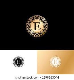 E letter or monogram. The original gold E letter symbol in a circle with lace ornament. Classic style.