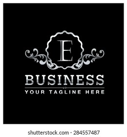 E letter Silver Luxury Logo template flourishes calligraphic elegant ornament lines. Business sign, identity for Restaurant, Royalty, Hotel, Heraldic, Jewelry, Fashion and other vector illustration