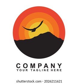 
eagle circle logo on the mountain red and yellow background