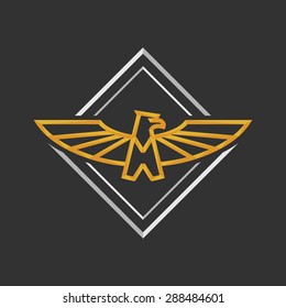 Eagle Logo Icon Design. Stock vector. Eagle Logo Icon Design. Stylized eagle spreads its wings. Golden and silver color on the dark background. 