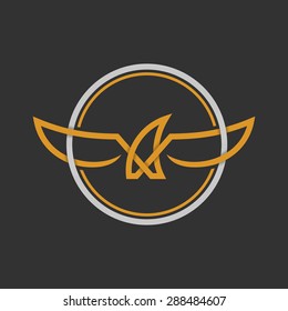 Eagle Logo Icon Design. Stock vector. Eagle Logo Icon Design. Stylized eagle spreads its wings. Golden and silver color on the dark background. 