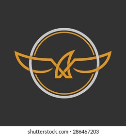 Eagle Logo Icon Design Template. Stock vector. Eagle Logo Icon Design. Stylized eagle spreads its wings. Golden and silver color on the dark background.