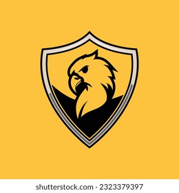 Eagle logo in a shield. Vector of an aggressive American eagle. symbol of power and protection. Bird protection logo. Silhouette of an eagle head. angry glare side pose. Nest for gamers and schools