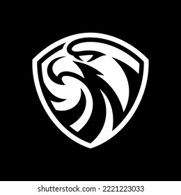 Eagle and shield logo design. Bird, falcon or hawk head badge emblem vector icon on dark background