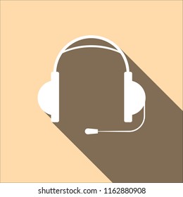 Earphones with microphone with long shadow on pink background