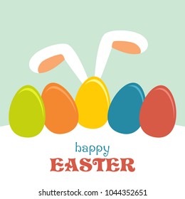 Ears of a rabbit, colored easter eggs and an inscription of Happy Easter.