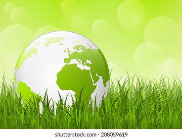 Earth globe on green grass