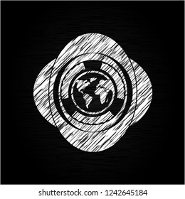 earth icon inside chalk emblem written on a blackboard