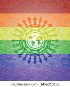 earth icon inside emblem on mosaic background with the colors of the LGBT flag