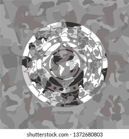 earth icon inside grey camouflage emblem