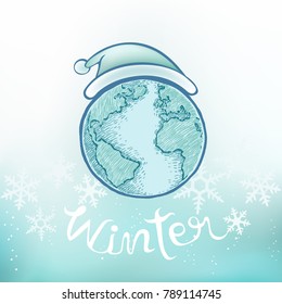 Earth with snowflakes on blue background. Hello winter text in hand drawn style. Cartoon design for Christmas and new year greeting card.
