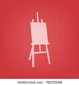 Easel sign. Vector. Knitted white icon on a red knitted background.