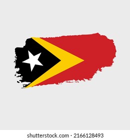 East Timor flag with grunge texture. Vector illustration of Timor Leste flag painted with brush with grunge effect and watercolor stroke. Happy Independence Day.