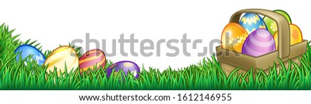 Easter background with basket or hamper full of Easter eggs in a field of grass.