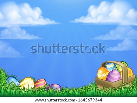 Easter background with basket or hamper full of Easter eggs in a field of grass.