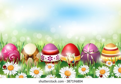 Easter Background with Colorful Eggs lying in Fresh Grass full of Flowers with Ladybirds in front of De-focused Lights