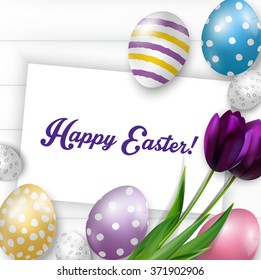 Easter background with colorful eggs, purple tulips and greeting card over white wood.Vector