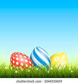 Easter background with eggs in grass and with copyspace