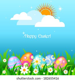 Easter background with Easter eggs laying in grass with daisy under beautiful sky
