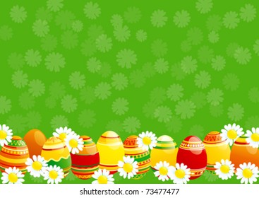 Easter background. Easter eggs and white camomiles on green background.